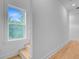 Bright staircase featuring white trim, a window providing natural light, and wood floor at 501 Joseph St, Charleston, SC 29412