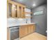 Wet bar featuring glass shelving, cabinets, wine cooler, sink and tiled backsplash at 501 Joseph St, Charleston, SC 29412