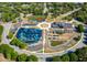 Aerial view of community amenities including playground, baseball field, parking, and community center surrounded by lush greenery at 5065 Durant Ave, North Charleston, SC 29405