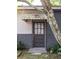 Back door entrance featuring brick and vinyl siding with a tree in view at 5065 Durant Ave, North Charleston, SC 29405