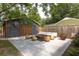 Outdoor seating area in backyard featuring modern furniture and a stylish rug at 5065 Durant Ave, North Charleston, SC 29405