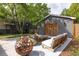 Inviting backyard patio featuring a stylish lounge area and rustic fire pit, perfect for outdoor entertaining at 5065 Durant Ave, North Charleston, SC 29405