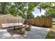 Landscaped backyard with a detached garage, stylish seating, and an outdoor living space at 5065 Durant Ave, North Charleston, SC 29405