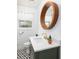 Updated bathroom with modern vanity, unique circle mirror, and patterned floor at 5065 Durant Ave, North Charleston, SC 29405