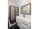 Chic bathroom with black and white tiling, walk-in shower, and gold-trimmed mirror at 5065 Durant Ave, North Charleston, SC 29405