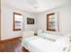 Bright bedroom with two twin beds, hardwood floors, and neutral color palette at 5065 Durant Ave, North Charleston, SC 29405