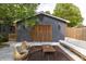 The detached garage with barn style doors creates a backyard entertaining space at 5065 Durant Ave, North Charleston, SC 29405