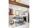 Bright kitchen with stainless appliances, farmhouse sink, white cabinets, wood beams, and decorative table at 5065 Durant Ave, North Charleston, SC 29405