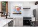 Updated kitchen with white countertops, tile backsplash, stainless steel appliances, and breakfast bar at 5065 Durant Ave, North Charleston, SC 29405
