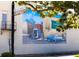 Colorful mural on the side of a building depicts a historical scene with people and vintage vehicles in a bustling Charleston at 5065 Durant Ave, North Charleston, SC 29405