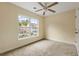 Well-lit bedroom featuring a ceiling fan and a large window showcasing a neighborhood view at 5104 E Liberty Park Cir, North Charleston, SC 29405