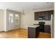 Cozy kitchen with dark wood cabinets, black appliances, and a functional center island at 5104 E Liberty Park Cir, North Charleston, SC 29405