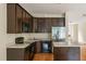 Kitchen area with wooden cabinets, black appliances, and a stainless steel refrigerator at 5104 E Liberty Park Cir, North Charleston, SC 29405