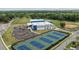 Aerial view of community tennis courts and recreation center surrounded by lush greenery and parking at 5104 E Liberty Park Cir, North Charleston, SC 29405