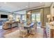 Open-concept dining area features a modern table, stylish chairs, and sliding glass doors to the outdoor patio at 593 Marsh Cove Cir, Summerville, SC 29486