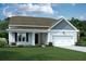 Charming single-Gathering home featuring a well-manicured lawn and an attached two-car garage at 593 Marsh Cove Cir, Summerville, SC 29486