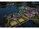 Aerial view showcasing tennis courts, garden, clubhouse, and scenic lake within a Primary-planned community at 629 Marsh Cove Cir, Summerville, SC 29486