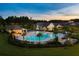 A beautiful pool area featuring palm trees, lounge chairs, and a covered bar, perfect for relaxing at 629 Marsh Cove Cir, Summerville, SC 29486