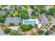 Aerial view of community pool, tennis courts, pond, and clubhouse surrounded by lush landscaping at 701 Hibbens Grant Blvd, Mount Pleasant, SC 29464