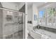 Bright bathroom with glass enclosed shower and soaking tub next to a window at 701 Hibbens Grant Blvd, Mount Pleasant, SC 29464