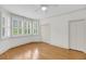 Bright bedroom featuring hardwood floors, shuttered windows, a ceiling fan, and a double-door closet at 701 Hibbens Grant Blvd, Mount Pleasant, SC 29464