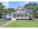 Inviting two-story home with a charming wrap-around porch and manicured lawn at 701 Hibbens Grant Blvd, Mount Pleasant, SC 29464