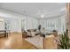 Bright living room featuring hardwood floors, large windows, and stylish furnishings at 701 Hibbens Grant Blvd, Mount Pleasant, SC 29464