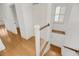 Staircase with hardwood steps and white railings, leading to the upper and lower levels at 701 Hibbens Grant Blvd, Mount Pleasant, SC 29464