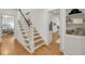 Bright staircase with wooden stairs and white railings and banister at 701 Hibbens Grant Blvd, Mount Pleasant, SC 29464