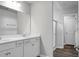 Bathroom with double vanity, white cabinets, framed mirror and glass enclosed shower at 717 Butter Rd, Bonneau, SC 29431