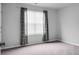 Bedroom with a window with black out curtains and gray carpet at 717 Butter Rd, Bonneau, SC 29431
