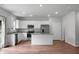 Well-lit kitchen boasts stainless appliances, granite countertops, and ample cabinet space at 717 Butter Rd, Bonneau, SC 29431