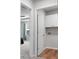 Bright laundry room featuring cabinets and a doorway view to a bedroom with gray carpet and curtains at 717 Butter Rd, Bonneau, SC 29431