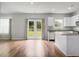 Open-concept living room featuring island, bright light, and hardwood floors at 717 Butter Rd, Bonneau, SC 29431