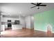 Bright living room featuring an open floor plan, hardwood floors, and a modern kitchen with stainless steel appliances at 717 Butter Rd, Bonneau, SC 29431
