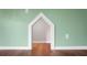 Living room detail with hardwood floors, childs play house, and modern wall color at 717 Butter Rd, Bonneau, SC 29431