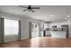 Living room with an open floor plan, hardwood floors, modern kitchen with stainless steel appliances, and a door to the yard at 717 Butter Rd, Bonneau, SC 29431