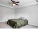 Cozy main bedroom features plush gray carpeting, a ceiling fan, and a large window letting in natural light at 717 Butter Rd, Bonneau, SC 29431