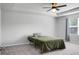 Spacious main bedroom with tray ceilings, a ceiling fan, large window, and plush gray carpeting at 717 Butter Rd, Bonneau, SC 29431