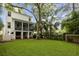Expansive backyard featuring a lush green lawn, a covered patio area with outdoor seating and grilling area at 732 Gate Post Dr, Mount Pleasant, SC 29464
