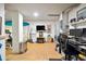 Finished basement featuring tile floors, TV, surfboard decor, and workout equipment at 732 Gate Post Dr, Mount Pleasant, SC 29464