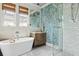 Elegant bathroom featuring soaking tub, subway tiled shower, and stylish blue wallpaper at 732 Gate Post Dr, Mount Pleasant, SC 29464