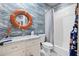 Nautical-themed bathroom featuring wave wallpaper, a life preserver, and subway tile shower at 732 Gate Post Dr, Mount Pleasant, SC 29464