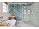Elegant bathroom featuring soaking tub, glass shower, vintage vanity, and blue patterned wallpaper at 732 Gate Post Dr, Mount Pleasant, SC 29464