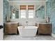 Luxurious bathroom featuring a soaking tub, dual vanities and stylish blue wallpaper at 732 Gate Post Dr, Mount Pleasant, SC 29464