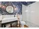 Elegant bathroom with navy wallpaper, glass shower and vintage-inspired vanity with round mirror at 732 Gate Post Dr, Mount Pleasant, SC 29464