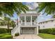 Inviting front of a two-story home showcasing a charming porch with hanging swings, a two-car garage and brick driveway at 732 Gate Post Dr, Mount Pleasant, SC 29464