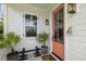Close-up of a charming front porch featuring a decorative door, stylish lighting, and potted plants adding curb appeal at 732 Gate Post Dr, Mount Pleasant, SC 29464