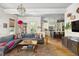 Bright and airy living room open to the kitchen, features stylish decor, hardwood floors, and ample natural light at 732 Gate Post Dr, Mount Pleasant, SC 29464