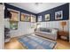 Stylish living room featuring blue accent wall, hardwood floors, and comfortable seating area at 732 Gate Post Dr, Mount Pleasant, SC 29464
